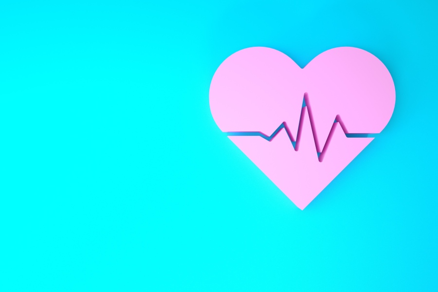 Grafika przedstawia różowe serce na turkusowym tle, na nim linię ilustrującą prawidłowy puls