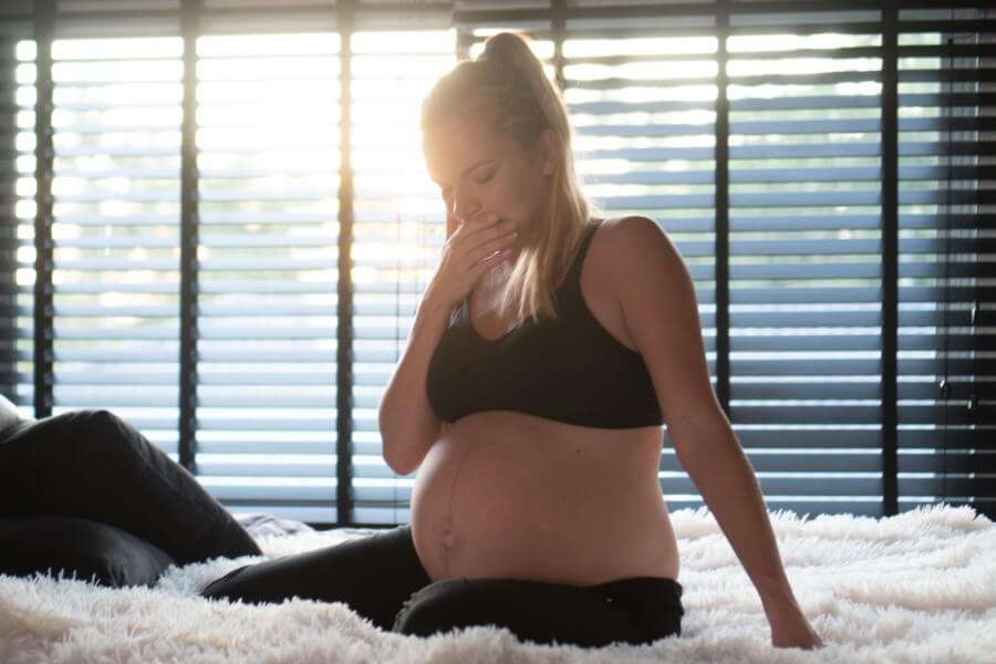 Kobieta w zaawansowanej ciąży zmaga się z objawami zgagi w ciąży.